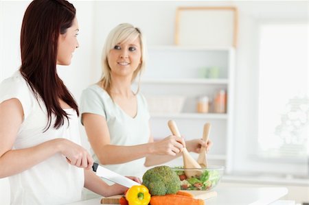 Young Women preparing dinner in a kitchen Stock Photo - Budget Royalty-Free & Subscription, Code: 400-05357667