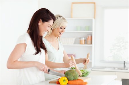 Joyful young Women preparing dinner in a kitchen Stock Photo - Budget Royalty-Free & Subscription, Code: 400-05357717
