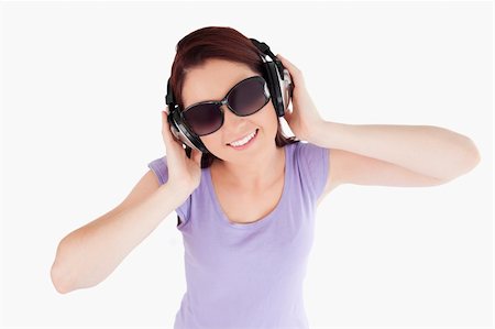simsearch:400-06769983,k - Red-haired Woman with headphones and sunglasses in a studio Foto de stock - Royalty-Free Super Valor e Assinatura, Número: 400-05357903