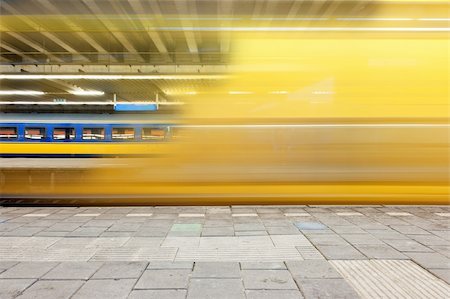 Train departing from a platform, leaving a blur and a glimpse on a waiting train on another platform Stock Photo - Budget Royalty-Free & Subscription, Code: 400-05358068