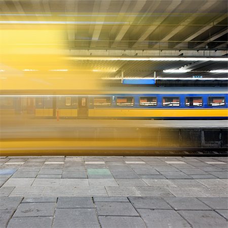 Train arriving at a platform, leaving a blur and a glimpse on a waiting train on another platform Stock Photo - Budget Royalty-Free & Subscription, Code: 400-05358196