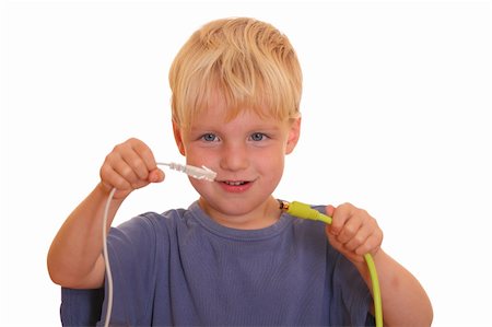 Young boy tries to connect two different cables Stock Photo - Budget Royalty-Free & Subscription, Code: 400-05358595