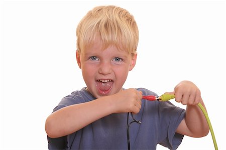 plug in with hand - Young boy tries to connect two different cables Stock Photo - Budget Royalty-Free & Subscription, Code: 400-05358596