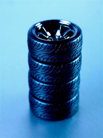 fast car close up - Rubber tyres with sports rims on a silver background Stock Photo - Budget Royalty-Free & Subscription, Code: 400-05358711