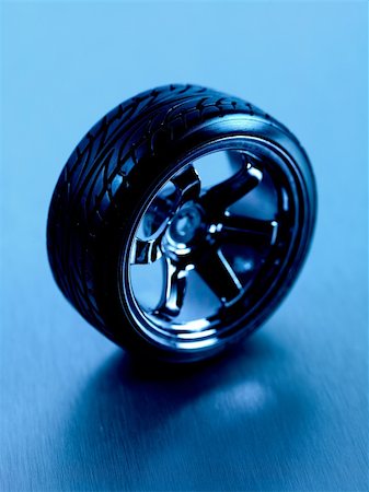 fast car close up - Rubber tyres with sports rims on a silver background Stock Photo - Budget Royalty-Free & Subscription, Code: 400-05358725
