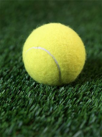 Sporting tennis balls on artificial green grass Stock Photo - Budget Royalty-Free & Subscription, Code: 400-05358742