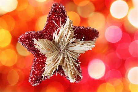simsearch:400-05359450,k - Star Christmas decoration against red blurred background Stock Photo - Budget Royalty-Free & Subscription, Code: 400-05359450