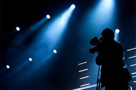 people and film production - Cameraman silhouette on a concert stage Stock Photo - Budget Royalty-Free & Subscription, Code: 400-05359492