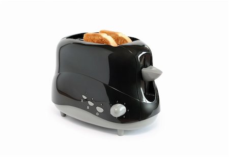 Two toasts inside black toaster on white background. Isolated with clipping path Photographie de stock - Aubaine LD & Abonnement, Code: 400-05359834