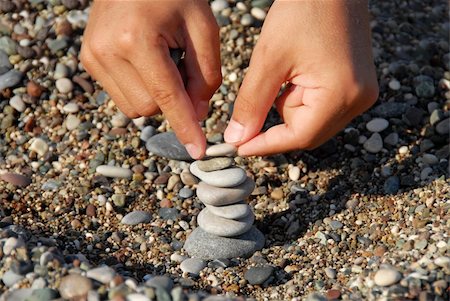 child hands building a rocks stack carefully Stockbilder - Microstock & Abonnement, Bildnummer: 400-05350293