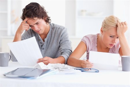 Stressed Couple with Paperwork in their living room Stock Photo - Budget Royalty-Free & Subscription, Code: 400-05350379