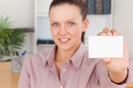 person holding up sign - Beautiful businesswoman holding a card in an office Stock Photo - Budget Royalty-Free & Subscription, Code: 400-05350460