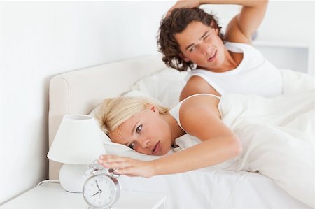 simsearch:400-04310916,k - Tired couple waking up in their bedroom Foto de stock - Royalty-Free Super Valor e Assinatura, Número: 400-05350562