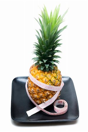 ripe vivid pineapple on a black plate with tape meter Stock Photo - Budget Royalty-Free & Subscription, Code: 400-05351293