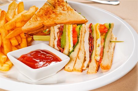 simsearch:695-05772521,k - fresh triple decker club sandwich with french fries on side Photographie de stock - Aubaine LD & Abonnement, Code: 400-05351302