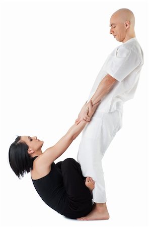 shiatsu - Young woman in traditional thai position with legs crossed, being stretched by therapist Foto de stock - Super Valor sin royalties y Suscripción, Código: 400-05352139