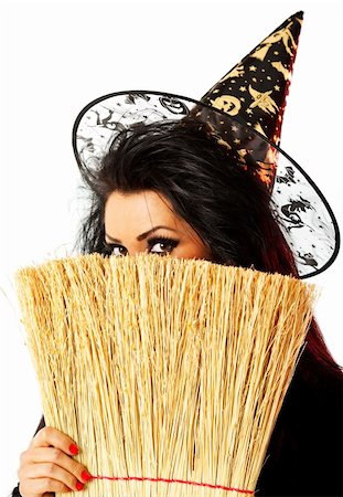 young female dressed up as a witch hiding behind broom Stock Photo - Budget Royalty-Free & Subscription, Code: 400-05352252