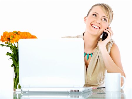 Beautiful happy female sitting behind desk with laptop, talking on the phone Photographie de stock - Aubaine LD & Abonnement, Code: 400-05352279