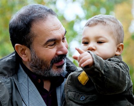 Close-up child being held by grandfather pointing forward Stock Photo - Budget Royalty-Free & Subscription, Code: 400-05352270