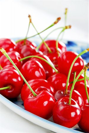simsearch:400-06855989,k - appetizing red fresh ripe cherries on blue plate Photographie de stock - Aubaine LD & Abonnement, Code: 400-05353318