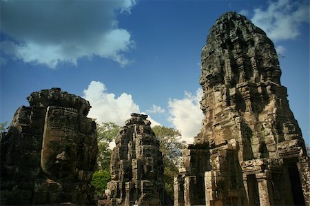 The Bayon is a Khmer temple at Angkor in Cambodia, built in the late 12th century or early 13th century as the official state temple of the Mahayana Buddhist King Jayavarman VII Following Jayavarman's death, it was modified and augmented by later Hindu and Theravada Buddhist kings in accordance with their own religious preferences.  The Bayon's most distinctive feature is the multitude of serene a Stock Photo - Budget Royalty-Free & Subscription, Code: 400-05353416