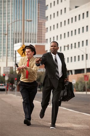 simsearch:400-04717565,k - Two businessmen try to outrun each other down the street Stock Photo - Budget Royalty-Free & Subscription, Code: 400-05353758