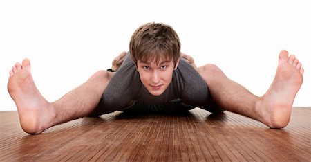Flexible young Caucasian man exercises over white background Stock Photo - Budget Royalty-Free & Subscription, Code: 400-05353784