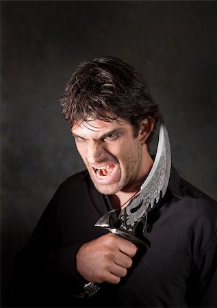 simsearch:400-05347613,k - Caucasian man with sharp knife yells over maroon background Stock Photo - Budget Royalty-Free & Subscription, Code: 400-05353805