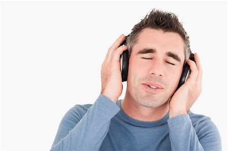 simsearch:400-05717354,k - Man enjoying some music against a white background Stock Photo - Budget Royalty-Free & Subscription, Code: 400-05353992