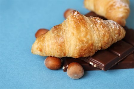 Croissants with chocolate and nuts on the blue background Stock Photo - Budget Royalty-Free & Subscription, Code: 400-05364089