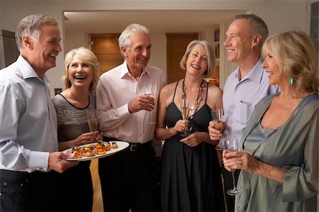 simsearch:400-05364195,k - Man Serving Hors D'oeuvres To His Guests At A Dinner Party Stock Photo - Budget Royalty-Free & Subscription, Code: 400-05364179
