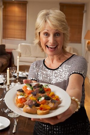 simsearch:400-05364195,k - Woman With Hors D'oeuvres For A Dinner Party Stock Photo - Budget Royalty-Free & Subscription, Code: 400-05364197