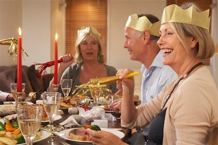 friends gathering christmas - Friends Wearing Party Hats At A Dinner Party Stock Photo - Budget Royalty-Free & Subscription, Code: 400-05364230