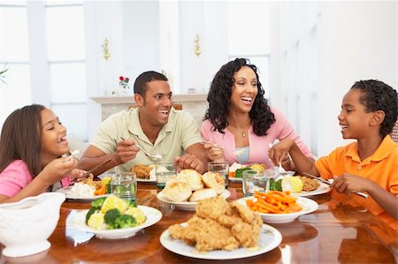 family eating chicken meat - Family Having A Meal Together At Home Stock Photo - Budget Royalty-Free & Subscription, Code: 400-05364294