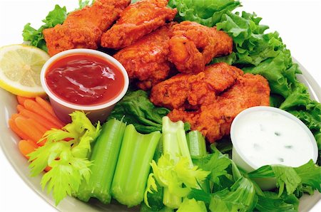 Spicy buffalo chicken wings served with hot and sour dip and crispy veggies Stockbilder - Microstock & Abonnement, Bildnummer: 400-05364360
