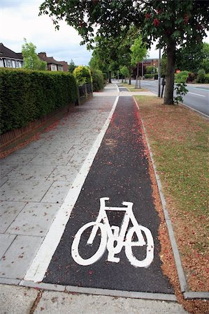 Bicycle lane with white mark of bicycle sign, London. Stockbilder - Microstock & Abonnement, Bildnummer: 400-05365444