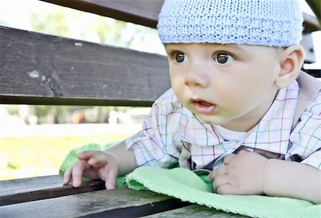 simsearch:400-07211187,k - A cute little baby is looking   ahead and is wearing a blue hat. The baby is  a boy   and has dark eyes. Photographie de stock - Aubaine LD & Abonnement, Code: 400-05367748