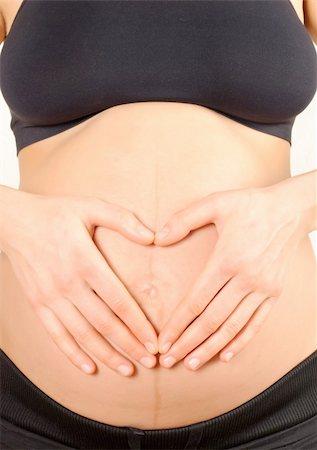 simsearch:400-04859723,k - pregnant woman, embracing the belly on a white background Fotografie stock - Microstock e Abbonamento, Codice: 400-05360058