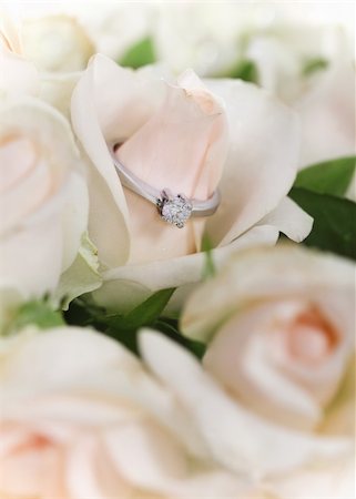flowers on white stone - Marriage proposal.   An engagement diamond ring in bouquet of roses Stock Photo - Budget Royalty-Free & Subscription, Code: 400-05360288