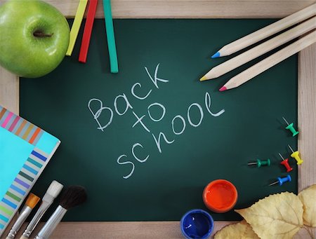 Green blackboard with brushes, book, apple and pencils Stock Photo - Budget Royalty-Free & Subscription, Code: 400-05360294