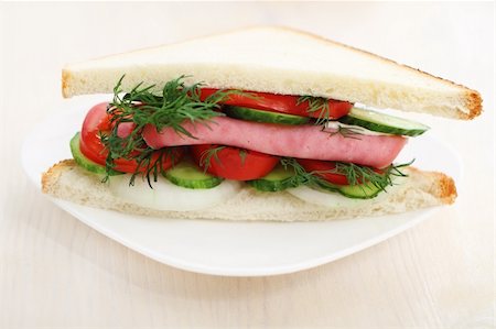 Tasty looking sandwich with ham and on a white plate. Stock Photo - Budget Royalty-Free & Subscription, Code: 400-05360297