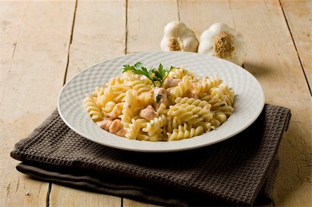 photo of delicious pasta with salmon and cream on wooden background Stockbilder - Microstock & Abonnement, Bildnummer: 400-05360670