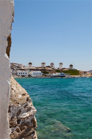 View of a row of windmills from a distance in Mykonos, Greece Photographie de stock - Aubaine LD & Abonnement, Code: 400-05361446