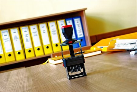 simsearch:400-04082460,k - Black stamp on wooden desk in office over files background Stock Photo - Budget Royalty-Free & Subscription, Code: 400-05361578