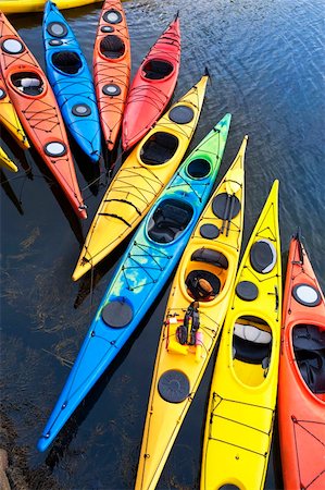 photo of empty canoe on water - Colorful fiberglass kayaks tethered to a dock as seen from above Stock Photo - Budget Royalty-Free & Subscription, Code: 400-05362222