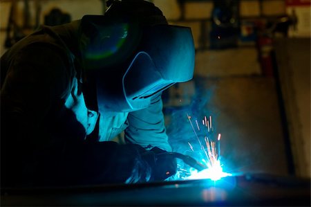 simsearch:400-05886105,k - Close-up photo of a welder at work with sparks flying around Photographie de stock - Aubaine LD & Abonnement, Code: 400-05362618