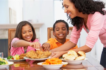 family eating chicken meat - Mother Serving A Meal To Her Children At Home Stock Photo - Budget Royalty-Free & Subscription, Code: 400-05374169