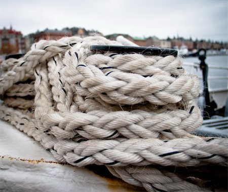 rope deck knot - A white and black rope tied onto a boat Stock Photo - Budget Royalty-Free & Subscription, Code: 400-05377761