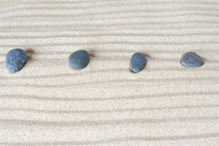 four stones on background of sand Stock Photo - Budget Royalty-Free & Subscription, Code: 400-05379057