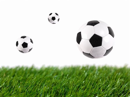 simsearch:400-08372849,k - Black and white soccer balls isolated on artificial grass Stock Photo - Budget Royalty-Free & Subscription, Code: 400-05379124
